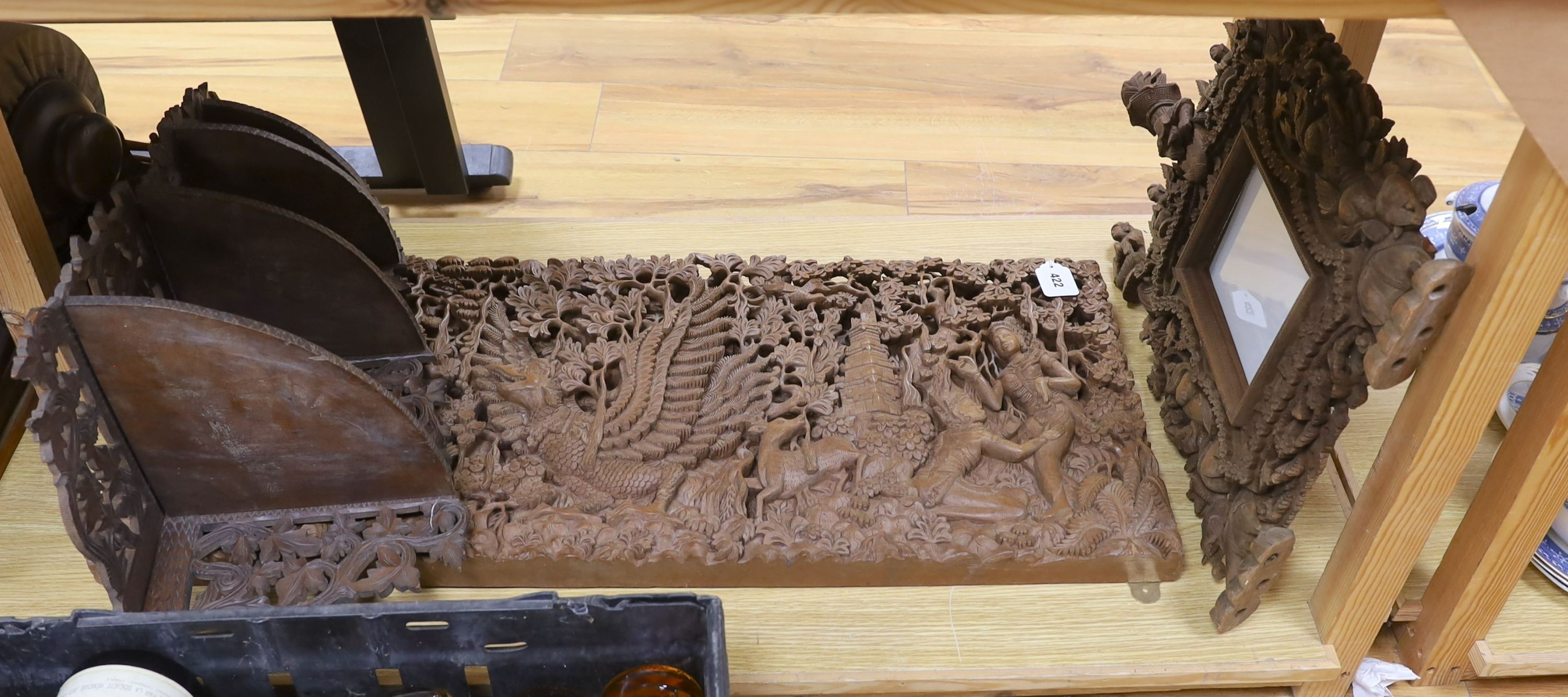 A Burmese or Indonesian graduated carved wall hanging what not, similar frame and carved panel